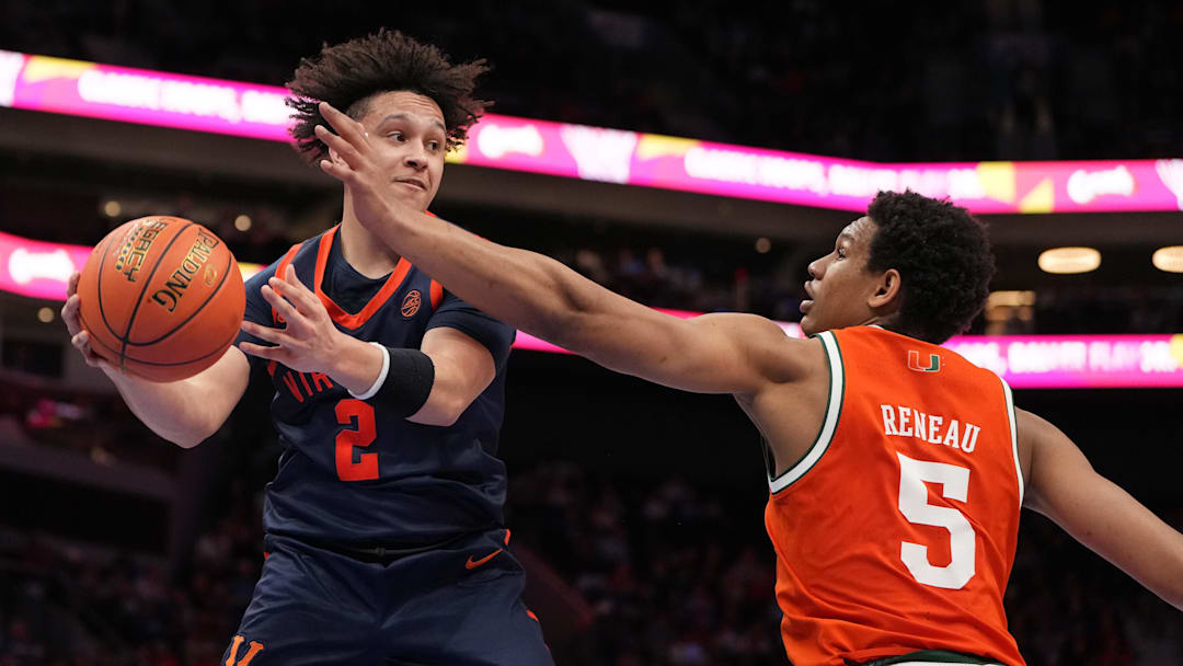 Mar 13, 2026; Charlotte, NC, USA; Virginia Cavaliers guard Chance Mallory (2) looks to pass as Miami (FL) Hurricanes forward Malik Reneau (5) defends in the second half at Spectrum Center. Mandatory Credit: Bob Donnan-Imagn Images
