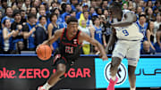 Feb 15, 2025; Durham, North Carolina, USA;  Stanford Cardinal guard Jaylen Blakes (21) drives the ball under pressure from Duke Blue Devils center Khaman Maluach (9) during the first half at Cameron Indoor Stadium. Mandatory Credit: Zachary Taft-Imagn Images