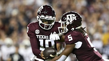 Nov 16, 2024; College Station, Texas, USA; Texas A&M Aggies quarterback Marcel Reed (10) hands off the ball to running back Amari Daniels (5) during the first quarter against the New Mexico State Aggies at Kyle Field. Mandatory Credit: Maria Lysaker-Imagn Images 