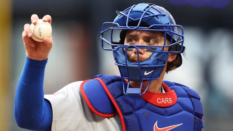 Chicago Cubs catcher Carson Kelly (15) receives a new ball from the umpire 