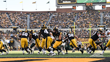 Nov 22, 2025; Iowa City, Iowa, USA; Iowa Hawkeyes quarterback Mark Gronowski (11) hands the ball off running back Jaziun Patterson (4) against the Michigan State Spartans during the second quarter at Kinnick Stadium. Mandatory Credit: Jeffrey Becker-Imagn Images