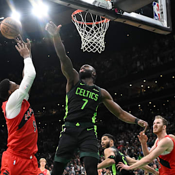 Nov 16, 2024; Boston, Massachusetts, USA; Boston Celtics center Neemias Queta (88) and guard Jaylen Brown (7) defend Toronto Raptors guard RJ Barrett (9) during the second half at the TD Garden. Mandatory Credit: Brian Fluharty-Imagn Images