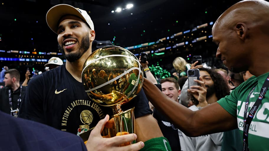 Boston Celtics forward Jayson Tatum celebrates with the Larry O’Brien Trophy after beating the Dallas Mavericks in game five of the 2024 NBA Finals to win the NBA Championship at TD Garden. | Peter Casey-Imagn Images