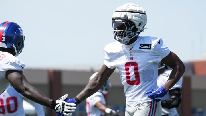 Jul 26, 2024; East Rutherford, NJ, USA; New York Giants linebacker Brian Burns (0) high-fives New York Giants defensive tackle Rakeem Nunez-Roches (93) during training camp at Quest Diagnostics Training Center.  