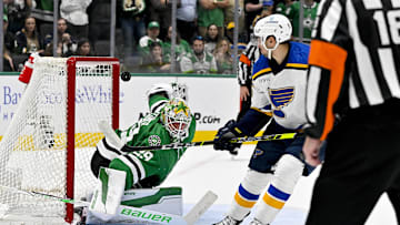 Apr 17, 2024; Dallas, Texas, USA; St. Louis Blues center Jordan Kyrou (25) looks on as his shot hits the crossbar behind Dallas Stars goaltender Jake Oettinger (29) during the overtime shootout at the American Airlines Center. Mandatory Credit: Jerome Miron-Imagn Images