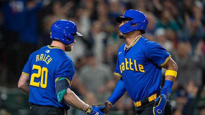 Seattle Mariners centerfielder Julio Rodriguez #44 of the Seattle Mariners is congratulated by first baseman Luke Raley (20) after scoring a run during the seventh inning against the Texas Rangers at T-Mobile Park on Sept 13.