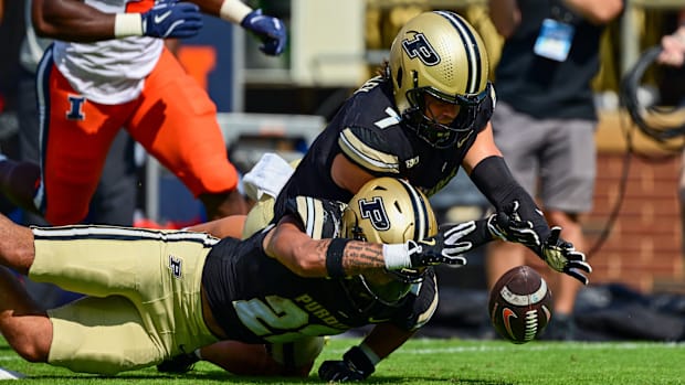 Purdue Boilermakers quarterback Garyt Odom (7) running back Antonio Harris (22) dive for a loose ball 