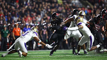 Sep 27, 2024; Piscataway, New Jersey, USA; Rutgers Scarlet Knights running back Kyle Monangai (5) fights for yards  as Washington Huskies safety Cameron Broussard (8) defends during the first half at SHI Stadium. Mandatory Credit: Vincent Carchietta-Imagn Images