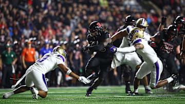 Sep 27, 2024; Piscataway, New Jersey, USA; Rutgers Scarlet Knights running back Kyle Monangai (5) fights for yards  as Washington Huskies safety Cameron Broussard (8) defends during the first half at SHI Stadium. Mandatory Credit: Vincent Carchietta-Imagn Images