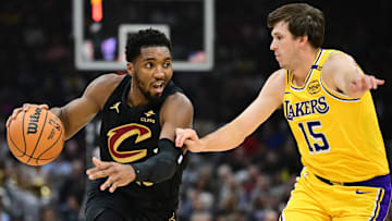 Oct 30, 2024; Cleveland, Ohio, USA; Cleveland Cavaliers guard Donovan Mitchell (45) drives to the basket against Los Angeles Lakers guard Austin Reaves (15) during the first quarter at Rocket Mortgage FieldHouse. Mandatory Credit: Ken Blaze-Imagn Images