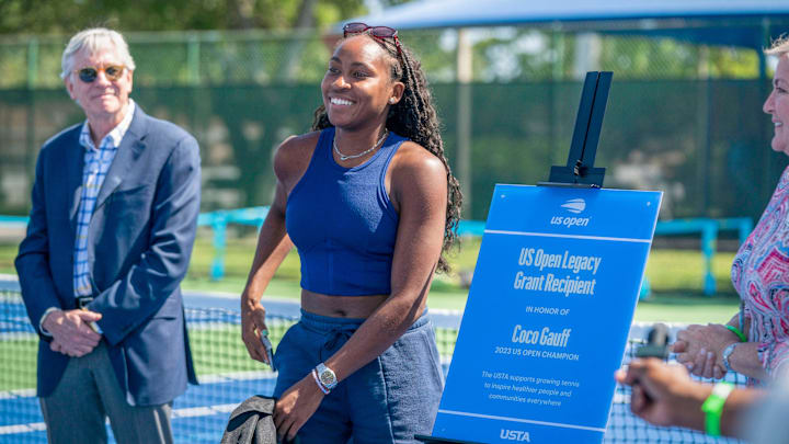 President of the United States Tennis Association Brian Hainline watches Coco Gauff smile during a ceremony celebrating two refurbished public tennis courts President of the United States Tennis Association Brian Hainline watches Coco Gauff smile during a ceremony celebrating two refurbished public tennis courts
