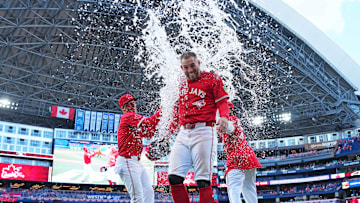 Jul 1, 2025; Toronto, Ontario, CAN; Toronto Blue Jays right fielder George Springer (4) gets the water bucket poured on him at the end of the ninth inning against the New York Yankees at Rogers Centre. Mandatory Credit: Nick Turchiaro-Imagn Images