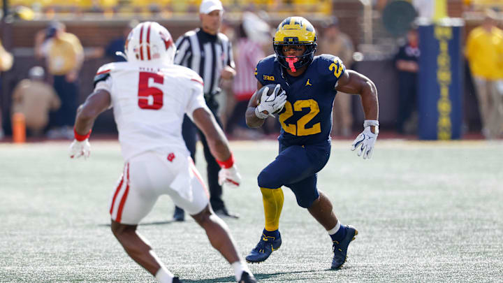 Oct 4, 2025; Ann Arbor, Michigan, USA;  Michigan Wolverines running back Justice Haynes (22) rushes at Wisconsin Badgers cornerback D'Yoni Hill (5) in the second half at Michigan Stadium.