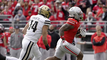Nov 9, 2024; Columbus, Ohio, USA; Ohio State Buckeyes running back Quinshon Judkins (1) is pursued by Purdue Boilermakers linebacker Yanni Karlaftis (14) during the first half at Ohio Stadium. Mandatory Credit: Barbara Perenic/USA TODAY Network via Imagn Images