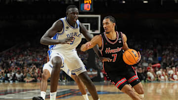 Apr 5, 2025; San Antonio, TX, USA; Houston Cougars guard Milos Uzan (7) dribbles the ball against Duke Blue Devils center Khaman Maluach (9) during the first half in the semifinals of the men's Final Four of the 2025 NCAA Tournament at the Alamodome. Mandatory Credit: Bob Donnan-Imagn Images