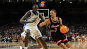 Apr 5, 2025; San Antonio, TX, USA; Houston Cougars guard Milos Uzan (7) dribbles the ball against Duke Blue Devils center Khaman Maluach (9) during the first half in the semifinals of the men's Final Four of the 2025 NCAA Tournament at the Alamodome. Mandatory Credit: Bob Donnan-Imagn Images