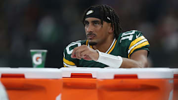 Love receives treatment on the Packers' sideline after going down with an apparent leg injury late in the fourth quarter.