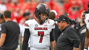 Spencer Rattler and Dowell Loggains before South Carolina's 24–14 loss to No. 1 Georgia on Sept. 16, 2023.