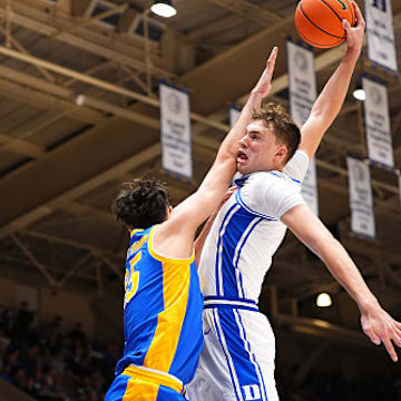 Cooper Flagg of the Duke Blue Devils dunks over Guillermo Diaz Graham of the Pittsburgh Panthers during the second half of the game at Cameron Indoor Stadium on January 07, 2025 in Durham, North Carolina. 