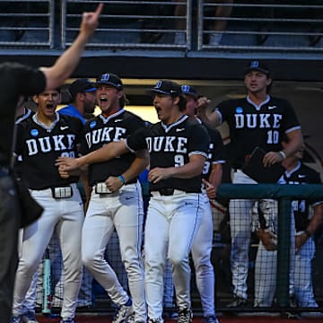 The home plate umpire ejects a Duke player for bringing a hard hat onto the field during the Athens Regional.