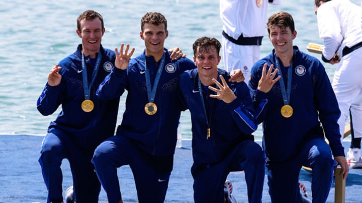 Nick Mead, Justin Best,, Michael Grady and Liam Corrigan pose on the podium with gold medals after winning the Olympic men's four rowing competition at Vaires-sur-Marne.