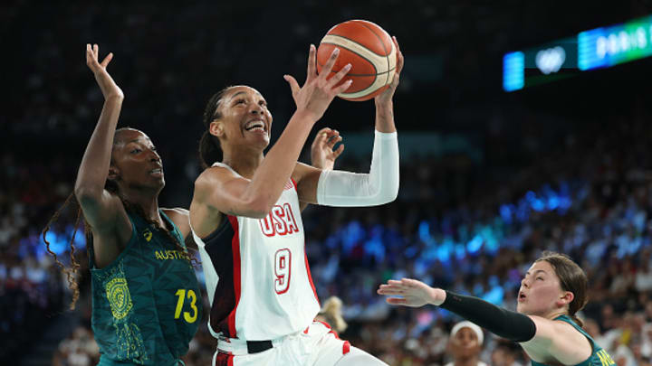 ARIS, FRANCE - AUGUST 09: A'Ja Wilson #9 of Team United States drives past Ezi Magbegor #13 and Jade Melbourne #2 of Team Australia during a Women's semifinal match between Team United States and Team Australia on day fourteen of the Olympic Games Paris 2024 at Bercy Arena