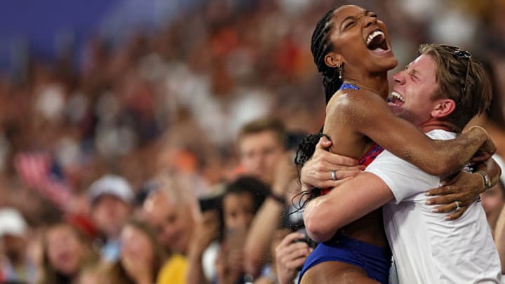 Tara Davis-Woodhall celebrates with her husband Hunter Woodhall after winning the gold medal in the women's long jump final in Paris.