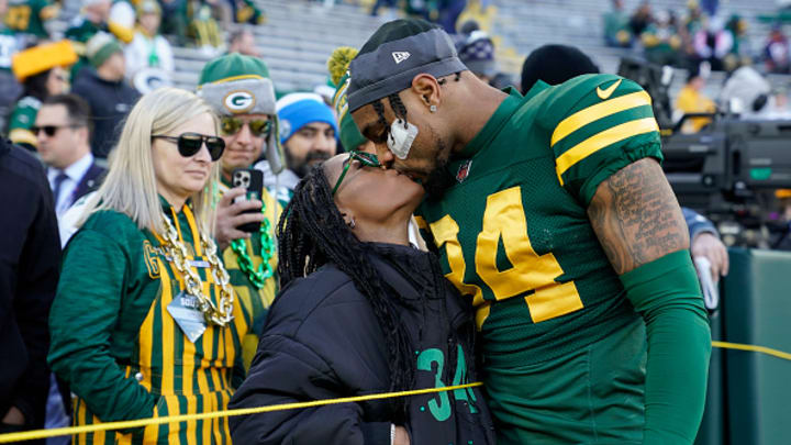 Jonathan Owens #34 of the Green Bay Packers kisses wife Simone Biles before the game against the Los Angeles Chargers at Lambeau Field on November 19, 2023 in Green Bay, Wisconsin. 