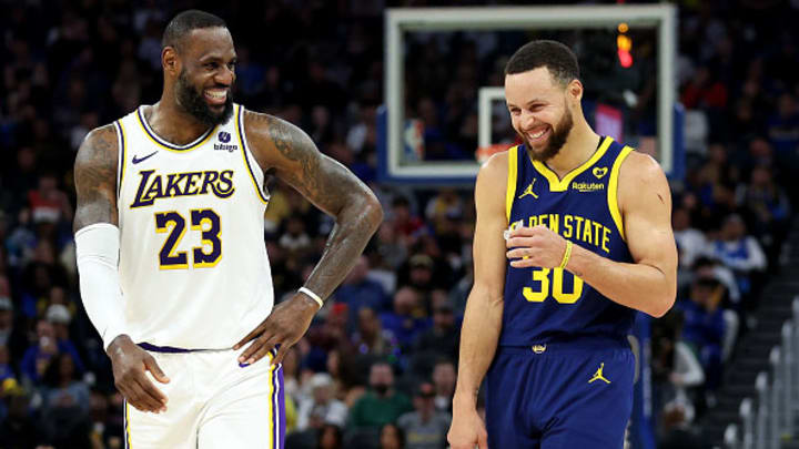 LeBron James and Steph Curry share a laugh on the court during a Warriors-Lakers game on January 27, 2024.