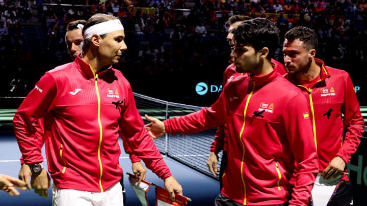 Rafael Nadal and Carlos Alcaraz talk on the court at the Davis Cup.