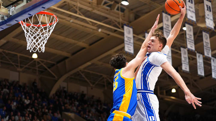 Cooper Flagg of the Duke Blue Devils dunks over Guillermo Diaz Graham of the Pittsburgh Panthers during the second half of the game at Cameron Indoor Stadium on January 07, 2025 in Durham, North Carolina. 