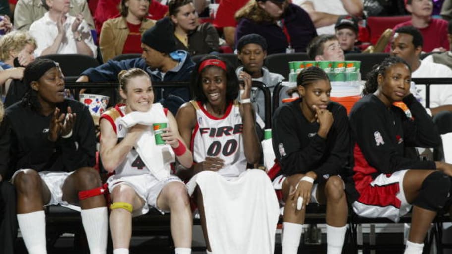 Members of the Portland Fire watch a 2002 game against the Washington Mystics. | Sam Forencich/WNBAE/Getty Images