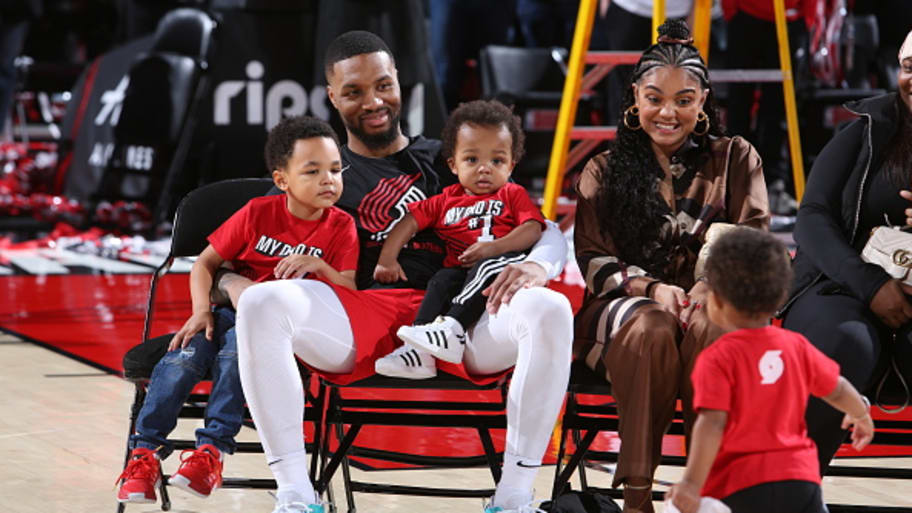 Damian Lillard of the Portland Trail Blazers smiles with his family after a 2022 game against the Charlotte Hornets at the Moda Center Arena in Portland, Oregon. | Photo by Sam Forencich/NBAE via Getty Images
