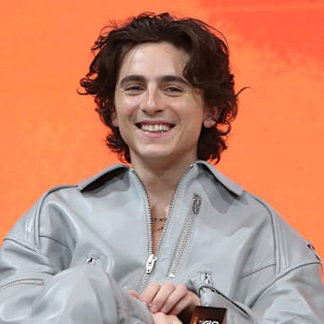 Actor Timothee Chalamet sits at a press conference for "Dune: Part Two."