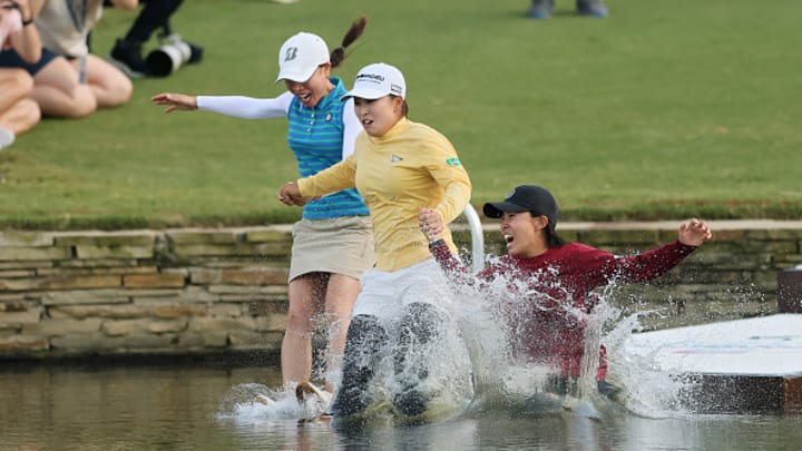 Chevron Championship winner Mao Saigo jumps in the pond with her manager and TV announcer after capturing the win. Chevron Championship winner Mao Saigo jumps in the pond with her manager and TV announcer after capturing the win.