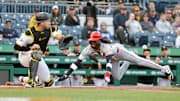 Elly De La Cruz flies safely into home against the Pittsburgh Pirates. 