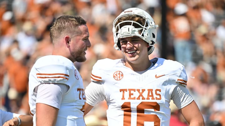 Arch Manning #16 and Quinn Ewers #3 of the Texas Longhorns talk on the field before a game at Cotton Bowl Stadium on October 12, 2024 in Dallas, Texas. Arch Manning #16 and Quinn Ewers #3 of the Texas Longhorns talk on the field before a game at Cotton Bowl Stadium on October 12, 2024 in Dallas, Texas.