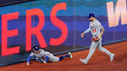 Dodgers' Kiké Hernández reacts to his collision with Andy Pages on a game-saving play in the ninth inning of Game 7's win in the World Series.