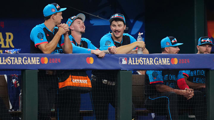 Bryan Reynolds #10 of the Pittsburgh Pirates, Jackson Merrill #3 of the San Diego Padres and Paul Skenes #30 of the Pittsburgh Pirates watch from the dugout during the 94th MLB All-Star Game at Globe Life Field on Tuesday, July 16