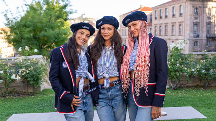 Mallory Swanson, Sophia Smith and Trinity Rodman of the United States pose in their Olympic opening ceremony outfits during a celebration for the start of the Paris 2024 Olympic games at the team hotel on July 26, 2024 in Marseille, France. 