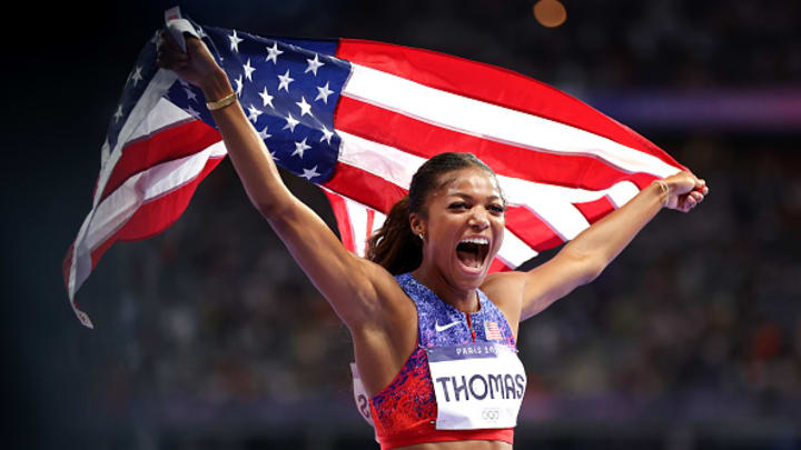 American sprinter Gabby Thomas poses with the American flag after winning gold in the 200m spring at the 2024 Paris Olympics. American sprinter Gabby Thomas poses with the American flag after winning gold in the 200m spring at the 2024 Paris Olympics.