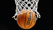 A basketball goes through a hoop at the 2025 March Madness tournament.