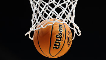 A basketball goes through a hoop at the 2025 March Madness tournament.