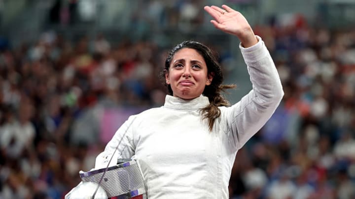 Nada Hafez of Team Egypt applauds fans after her victory against Elizabeth Tartakovsky of Team United States (not pictured) in the Fencing Women's Sabre Individual Table of 32 on day three of the Olympic Games Paris 2024 at Grand Palais on July 29, 2024 in Paris, France.