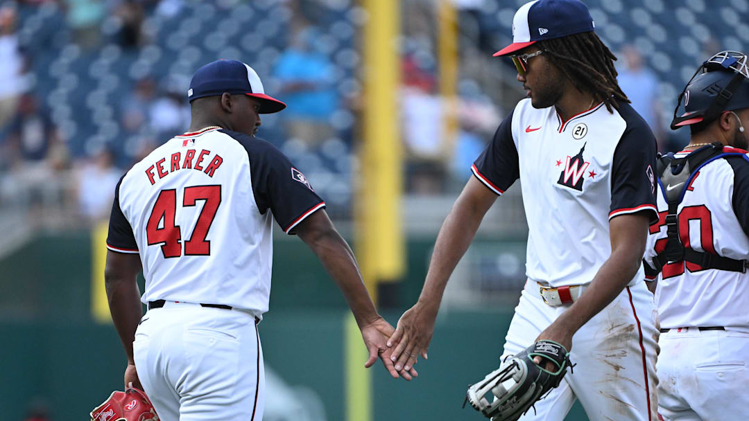 Sep 15, 2024; Washington, District of Columbia, USA; Washington Nationals relief pitcher Jose Ferrer (47) and left fielder James Wood (29) celebrate after defeating the Miami Marlins at Nationals Park. 