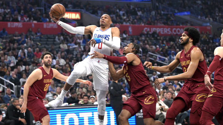Apr 7, 2024; Los Angeles, California, USA; Los Angeles Clippers guard Russell Westbrook (0) drives past Cleveland Cavaliers forward Isaac Okoro (35) in the first half at Crypto.com Arena. Mandatory Credit: Jayne Kamin-Oncea-USA TODAY Sports