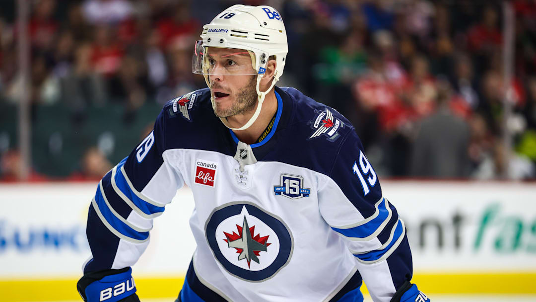 Nov 15, 2025; Calgary, Alberta, CAN; Winnipeg Jets center Jonathan Toews (19) during the face off against the Calgary Flames during the warmup period at Scotiabank Saddledome. Mandatory Credit: Sergei Belski-Imagn Images