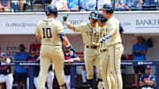 Jun 1, 2025; Oxford, MS, USA; Georgia Tech Yellowjackets firstbase Kent Schmidt (10) reacts with shortstop Kyle Lodise (2), outfielder Drew Burress (8), and second baseman Alex Hernandez (4), after a home run during the first inning against the Mississippi Rebels. Mandatory Credit: Petre Thomas-Imagn Images