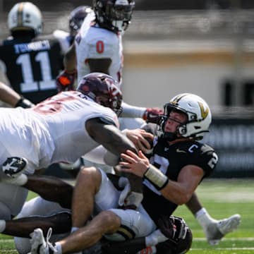 Aug 31, 2024; Nashville, Tennessee, USA;  Vanderbilt Commodores quarterback Diego Pavia (2) gets sacked by Virginia Tech Hokies defensive lineman Aeneas Peebles (16) and defensive lineman Antwaun Powell-Ryland (52) during the second half at FirstBank Stadium. Mandatory Credit: Steve Roberts-Imagn Images