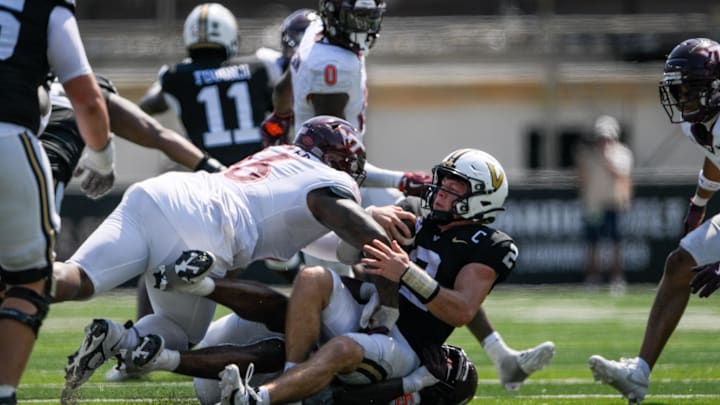 Aug 31, 2024; Nashville, Tennessee, USA;  Vanderbilt Commodores quarterback Diego Pavia (2) gets sacked by Virginia Tech Hokies defensive lineman Aeneas Peebles (16) and defensive lineman Antwaun Powell-Ryland (52) during the second half at FirstBank Stadium. Mandatory Credit: Steve Roberts-Imagn Images